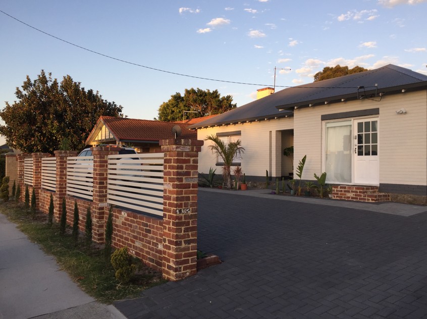 Renovated single-storey home with brick and timber front fencing
