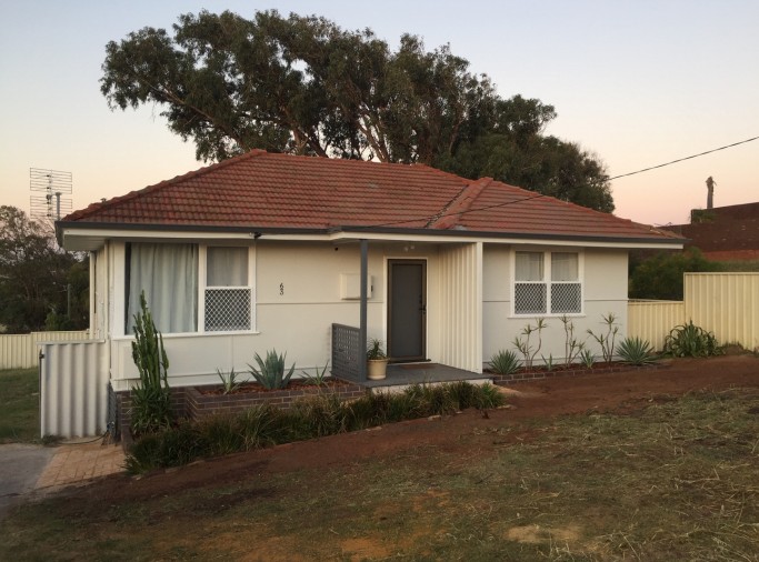 Renovated cottage with landscaped front garden at dusk