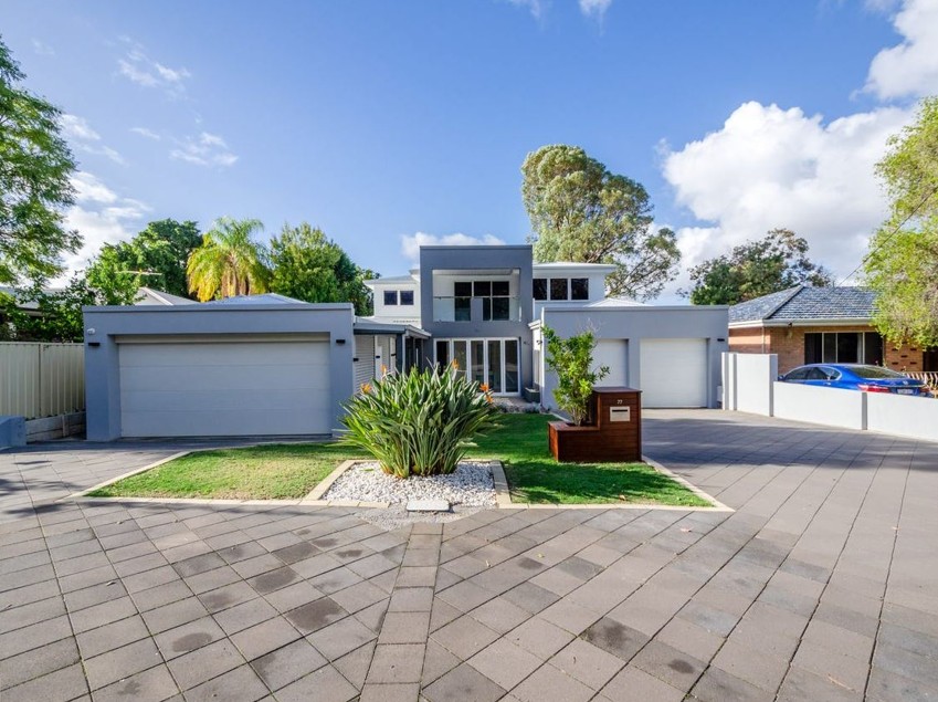 Modern two-storey home with double garages and paved driveway